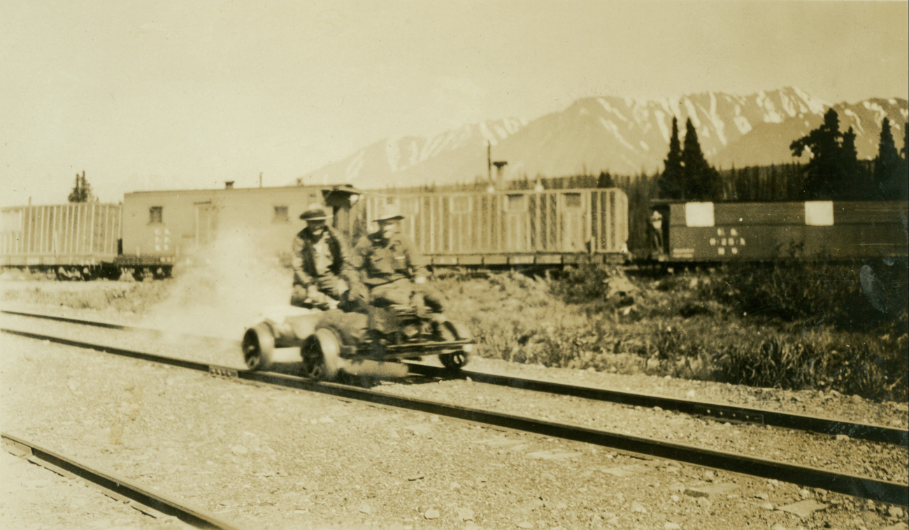 A gasoline powered velocipede underway near a railroad siding on the Anchorageto Fairbanks railway
