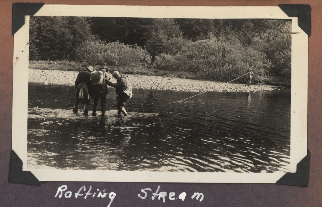 Work party crossing small stream on improvised raft - perhaps a little too muchweight