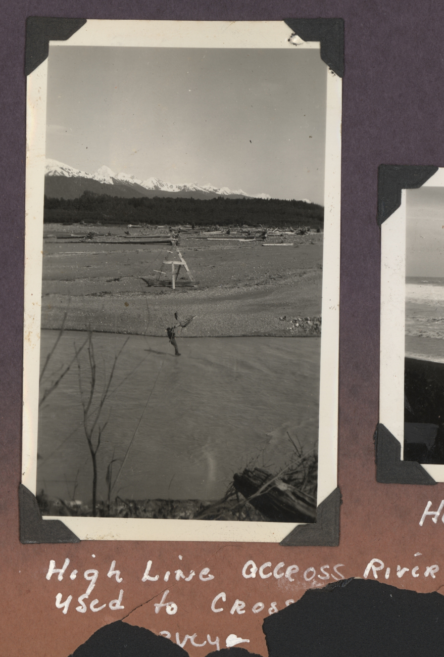 Surveyor crossing river on highline