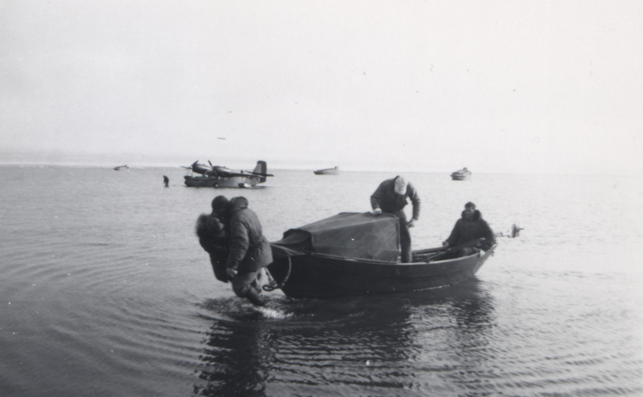 Walking a skiff into shore from the seaplane