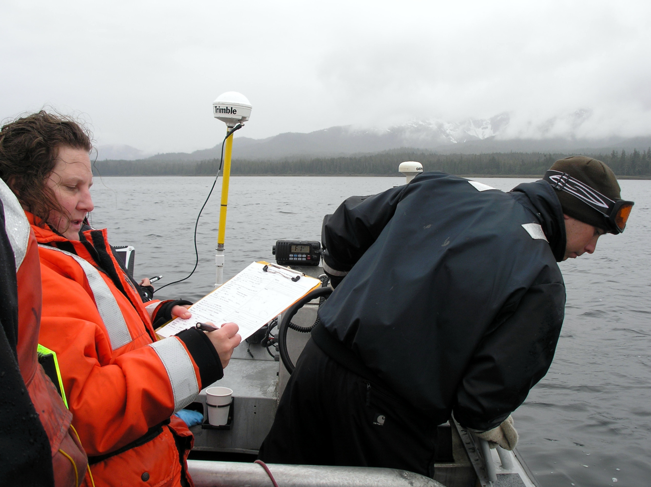 Small boat with Trimble GPS receiver being used for shoreline mapping and aerial photography editing