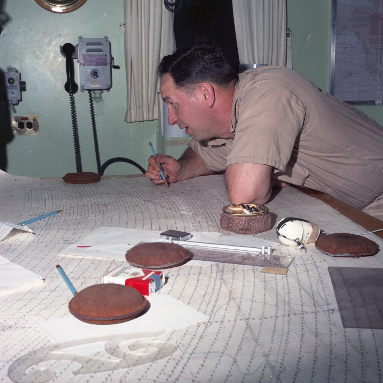Commander Bill Hayes, commanding officer of ESSA Ship DAVIDSON, checkinghydrographic survey work