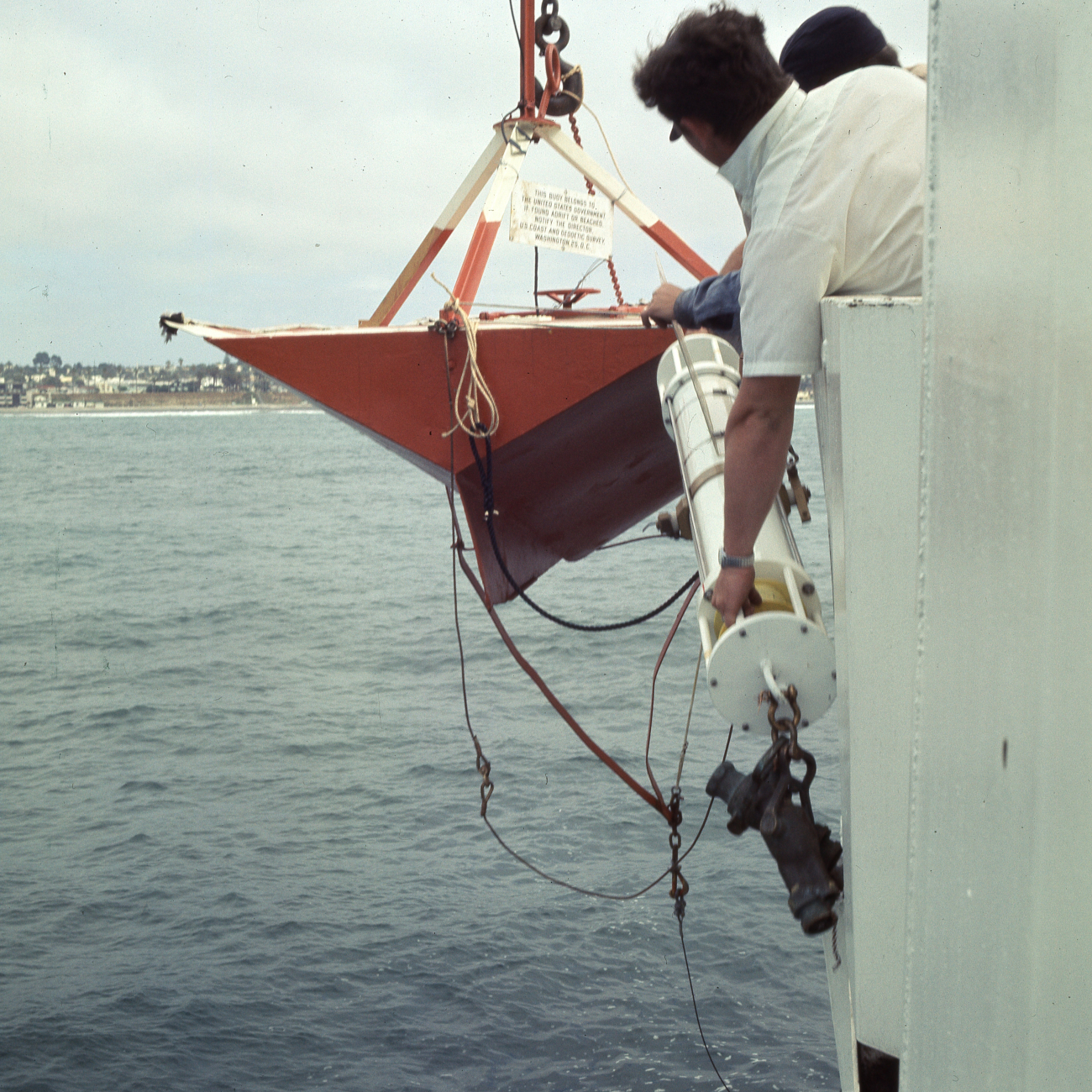 Deploying current meter buoy with meter attached off ESSA Ship DAVIDSON