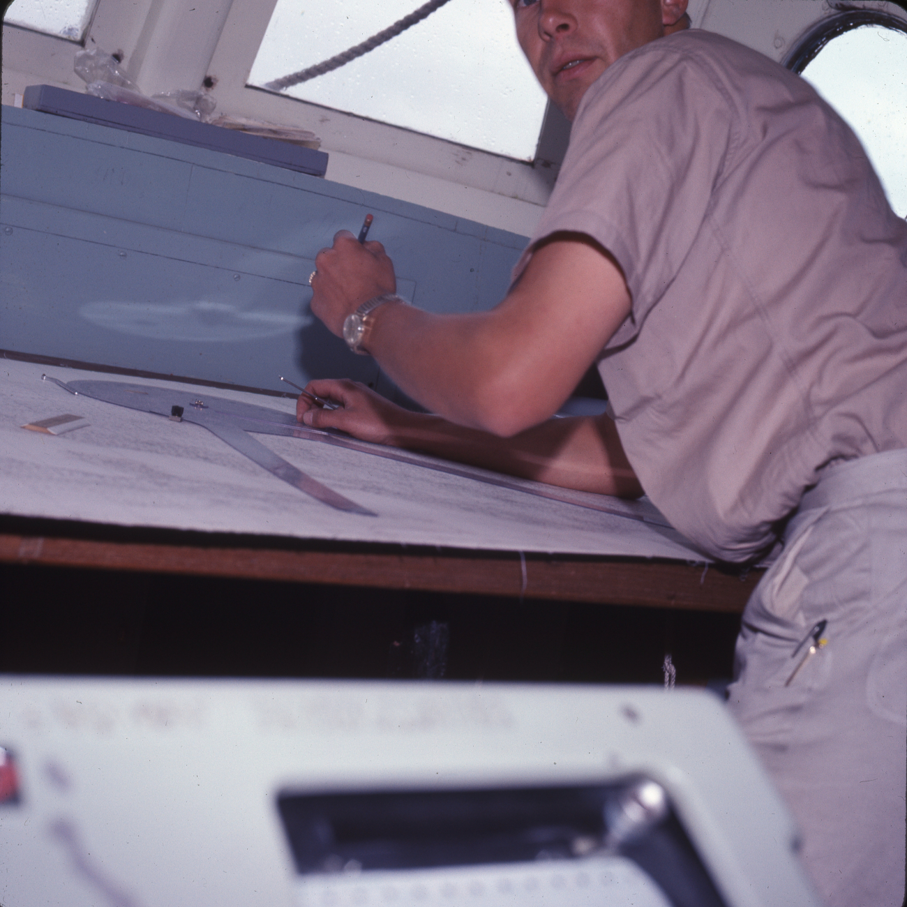 Lieutenant Melvin Maki plotting soundings on boat sheet