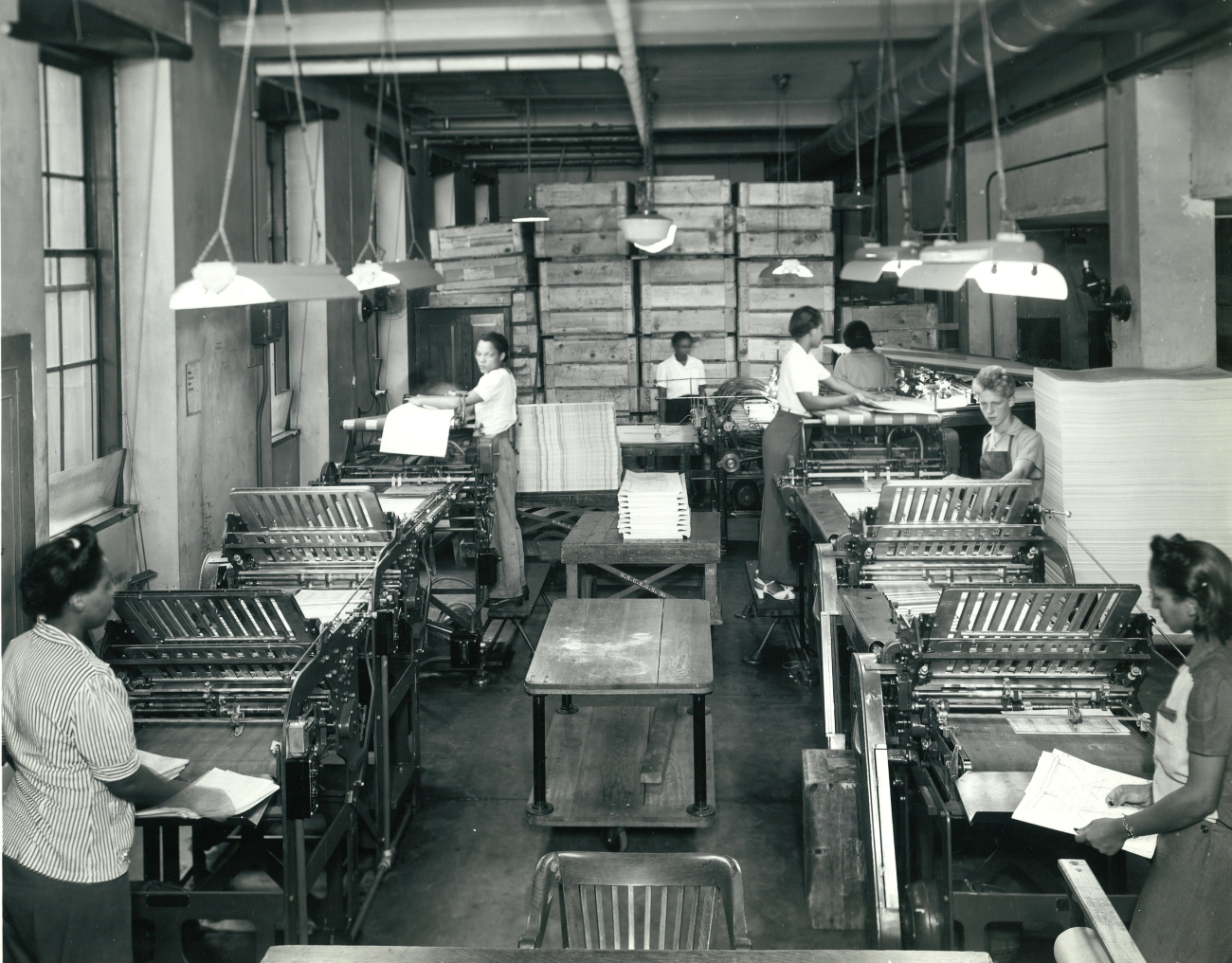 Women working in the cutting and folding rooms - the final preparation of mapsand charts prior to shipping to users
