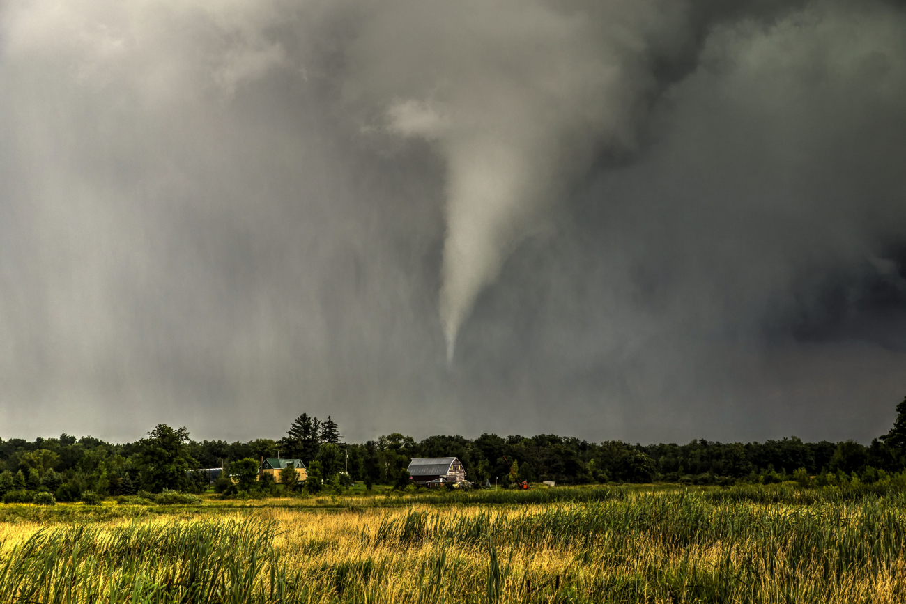 A ghostly tornado skips and hops across the central Minnesota landscape as itlifted momentarily narrowly missing this rural farmstead
