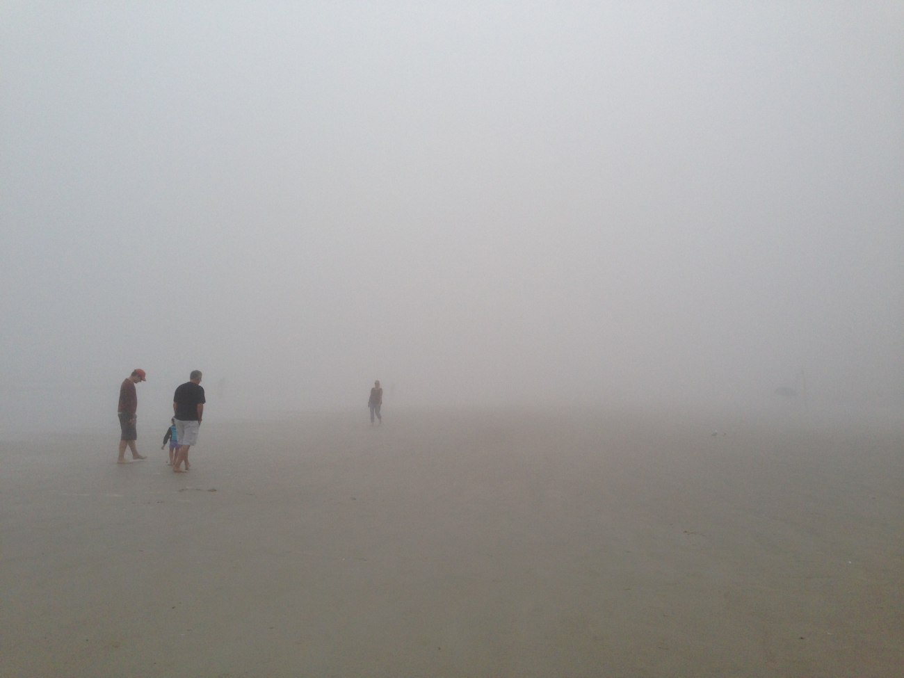 Ocean fog thick as split pea soup as the old adage goes greets morningwalkers on the beach in New Smyrna Beach, Florida