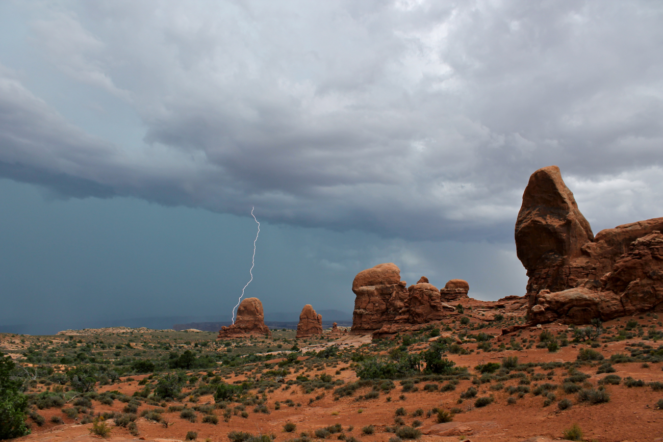 Lightning strikes an isolated rock formation as a fast-moving thunder stormmoves into Arches National Park