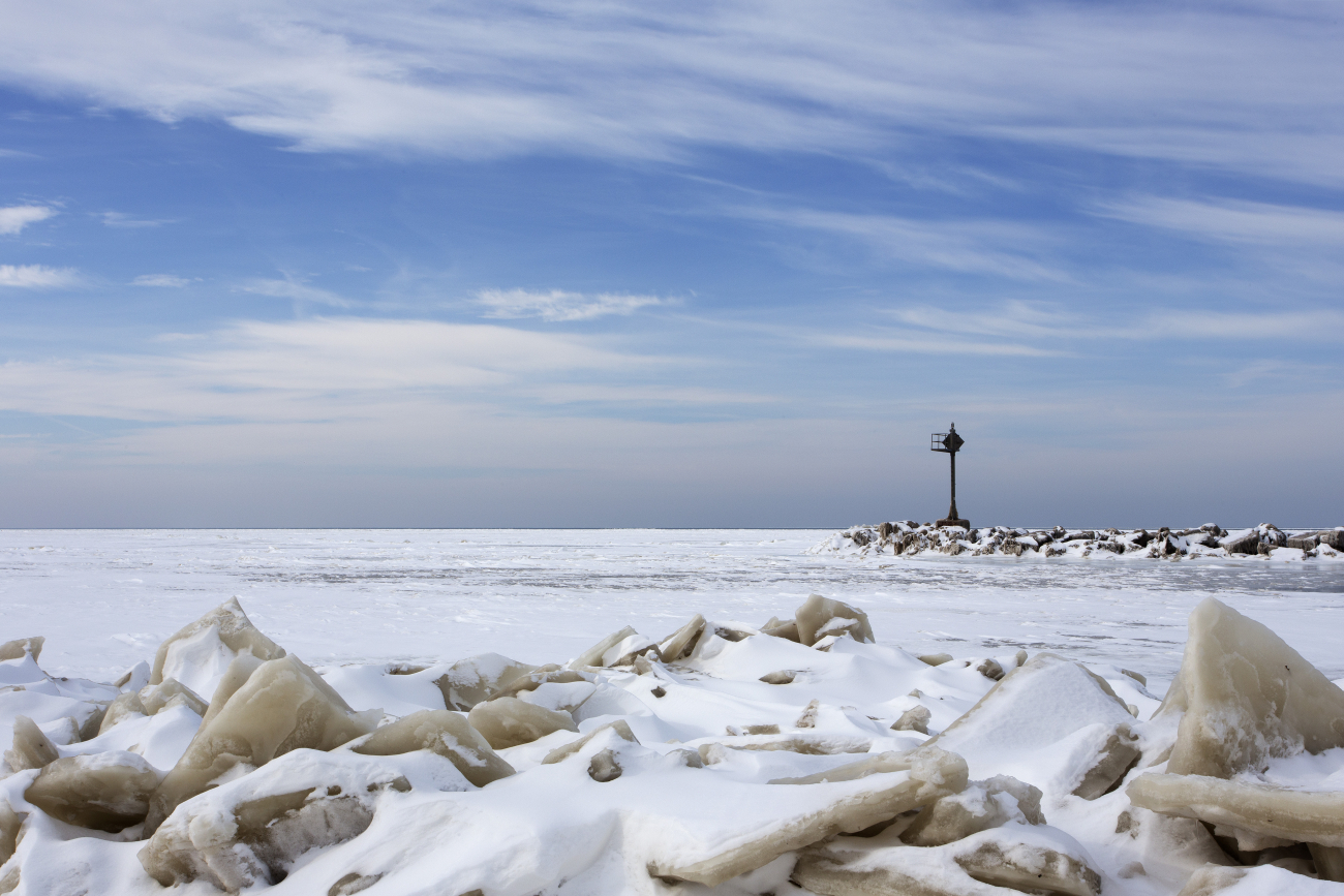 Fractured plates of ice litter the snowy Lake Erie shoreline