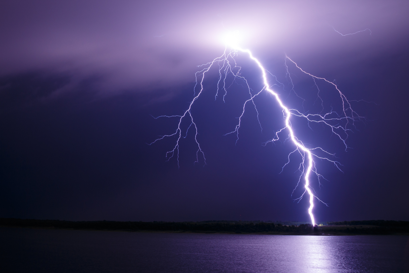 A single, powerful lightning bolt crashes to earth
