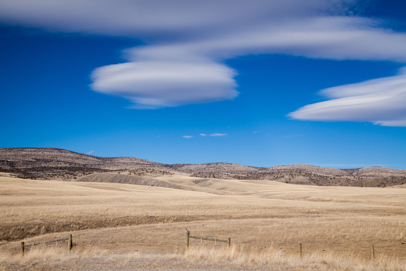 Lenticular clouds hang above the hills of Jefferson County, Montana