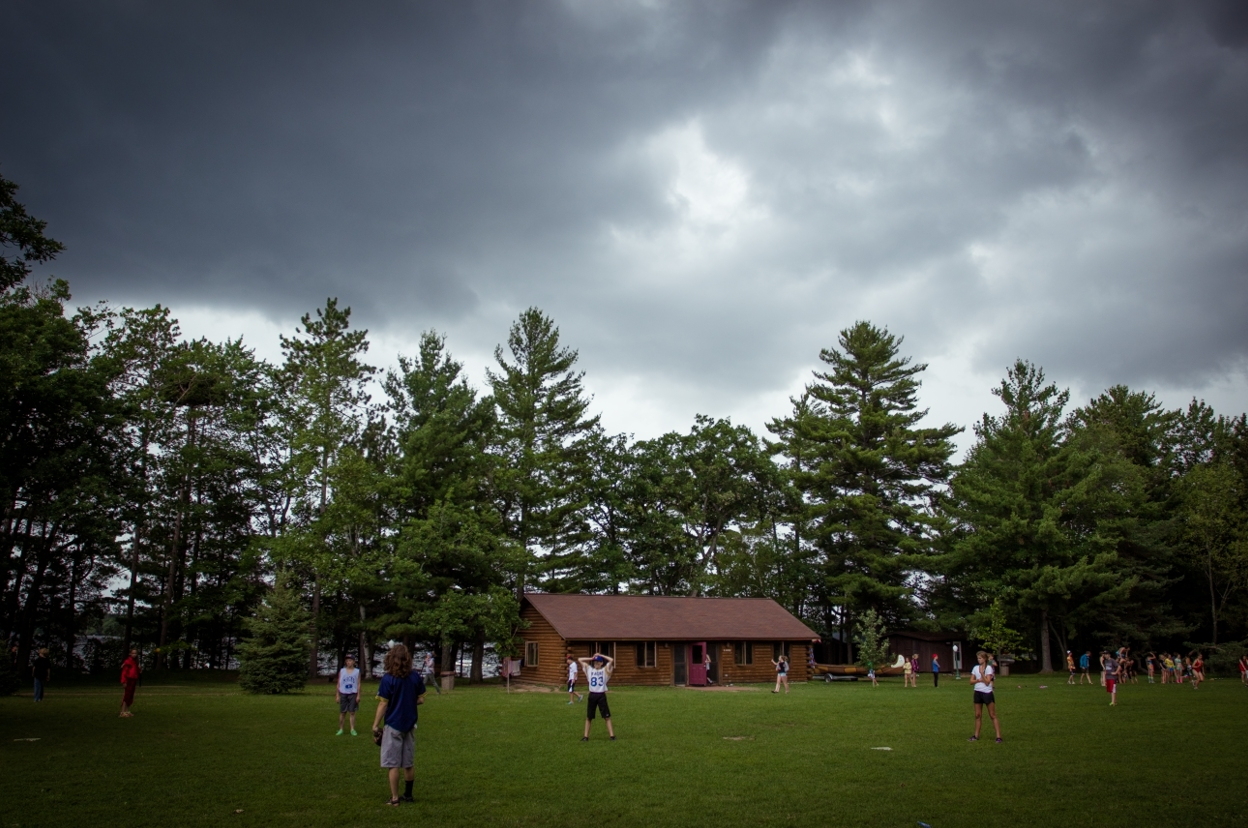 A dark storm started rolling in as kids began playing the afternoongame at Camp Manitou