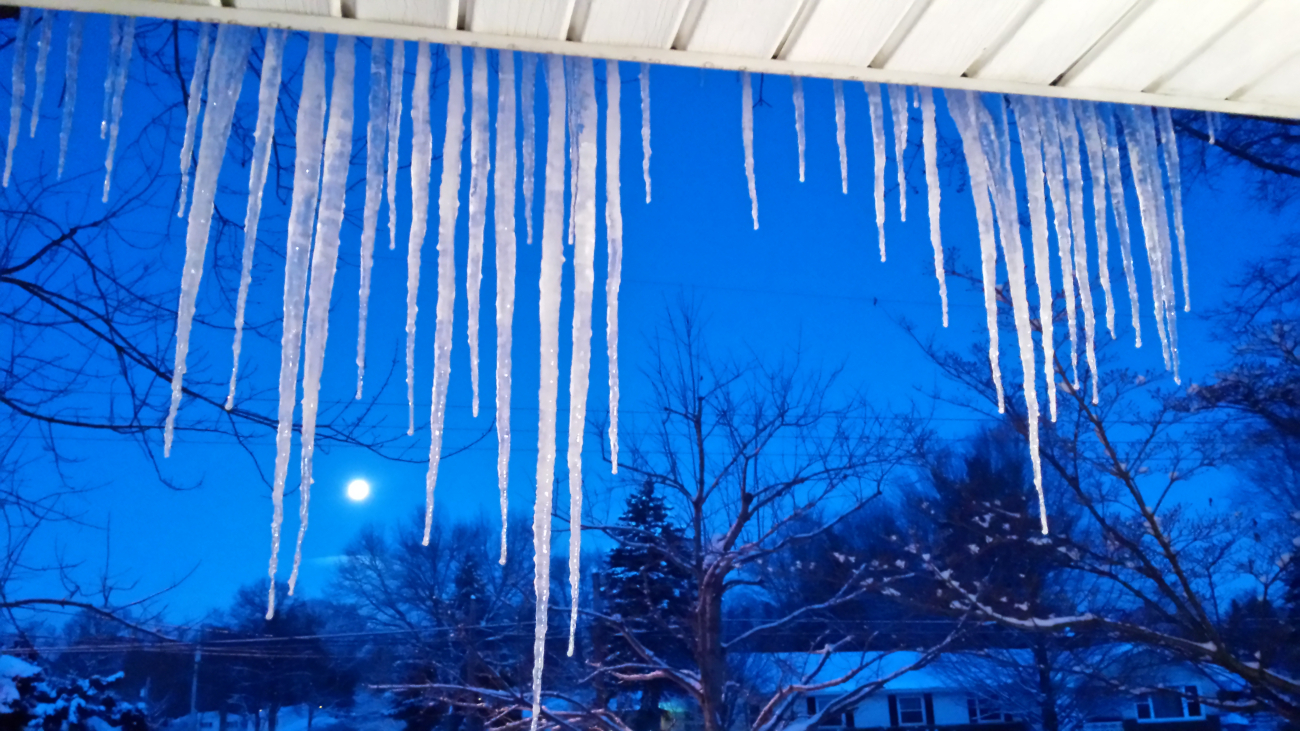 Icicles at dawn with moonset