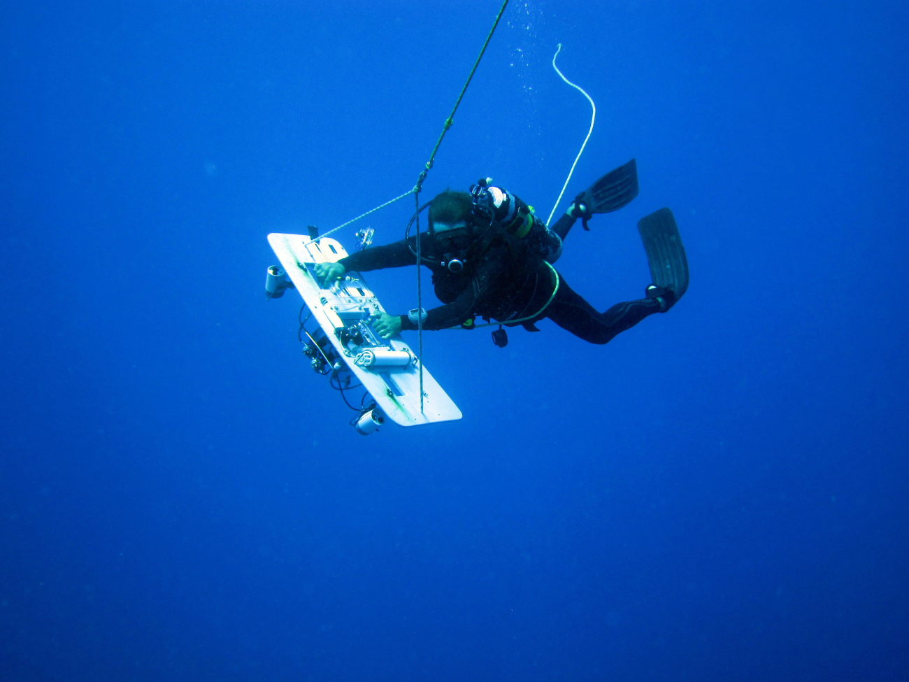 Diver seemingly suspended in space while towboarding through exceptionallyclear open water