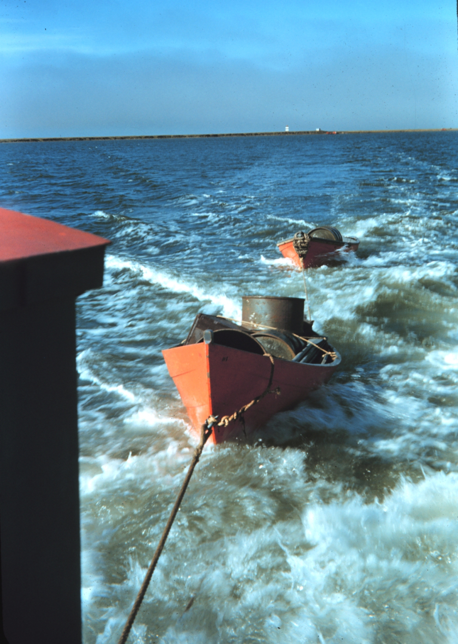 Survey launch towing dinghies after supplying observing camp