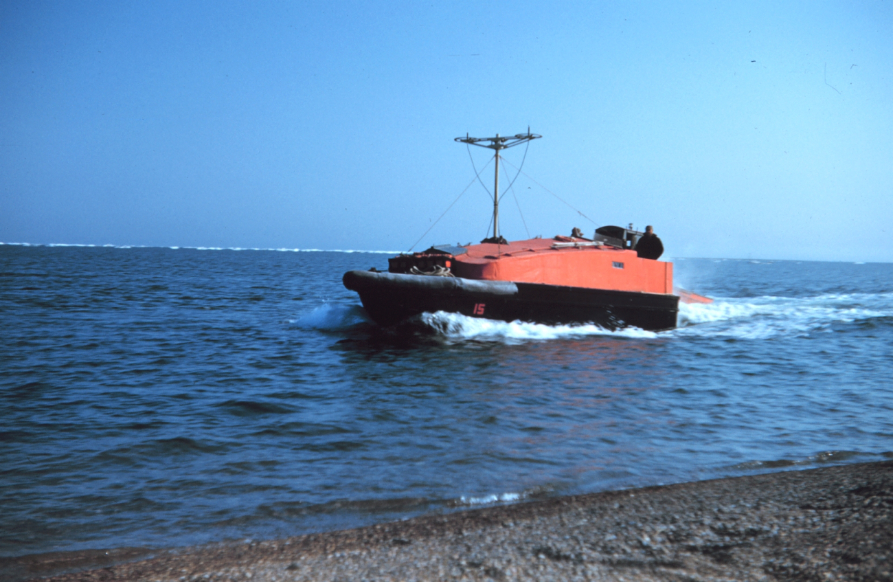 Survey launch running near the shore at Cross Island