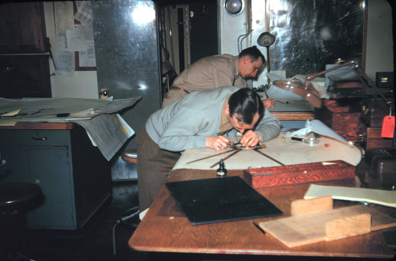 Hal Demuth on the left and Miller Tonkel plotting hydrographyNote metallic three-arm protractor