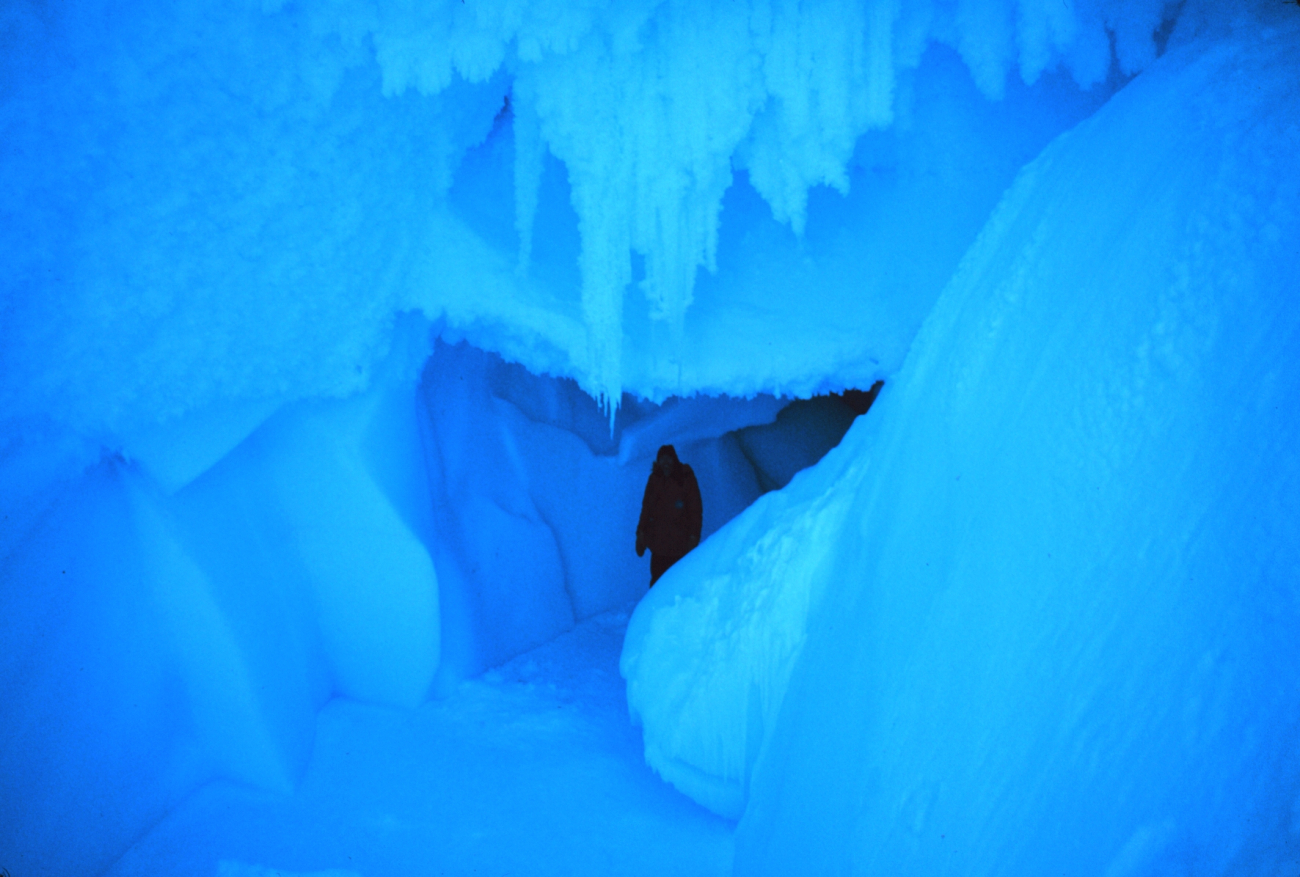 Ice spelunker in cave passageway at Erebus Glacier tongue