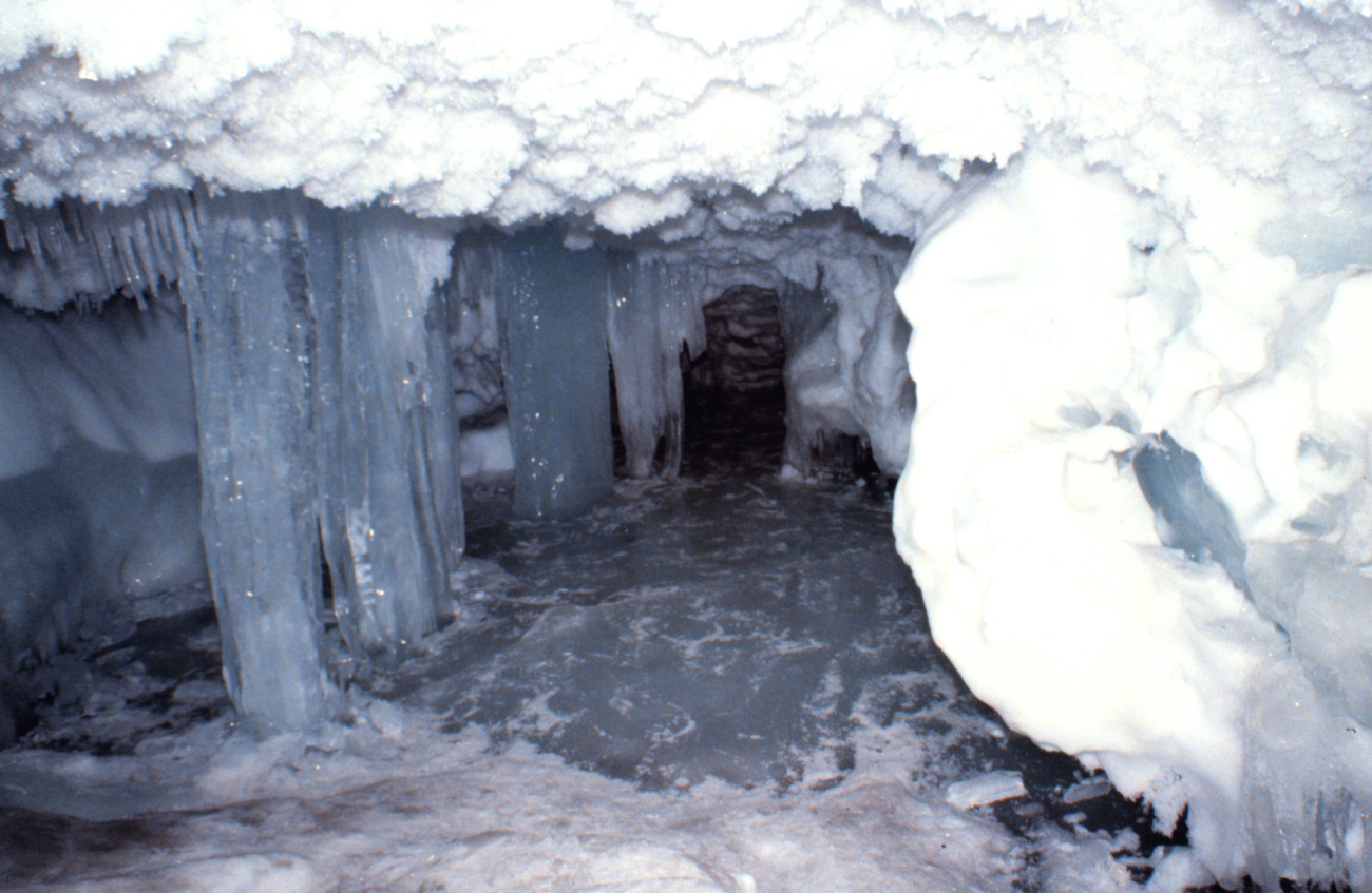 Ice stalactites, columns of ice, refrozen floor of cave, and ice crystals