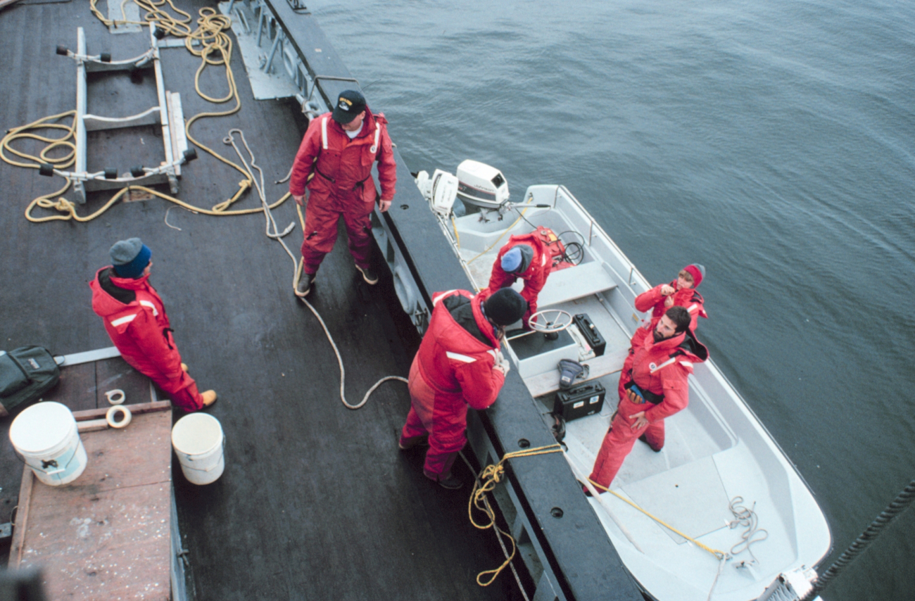 Scientists departing in skiff on marine mammal study