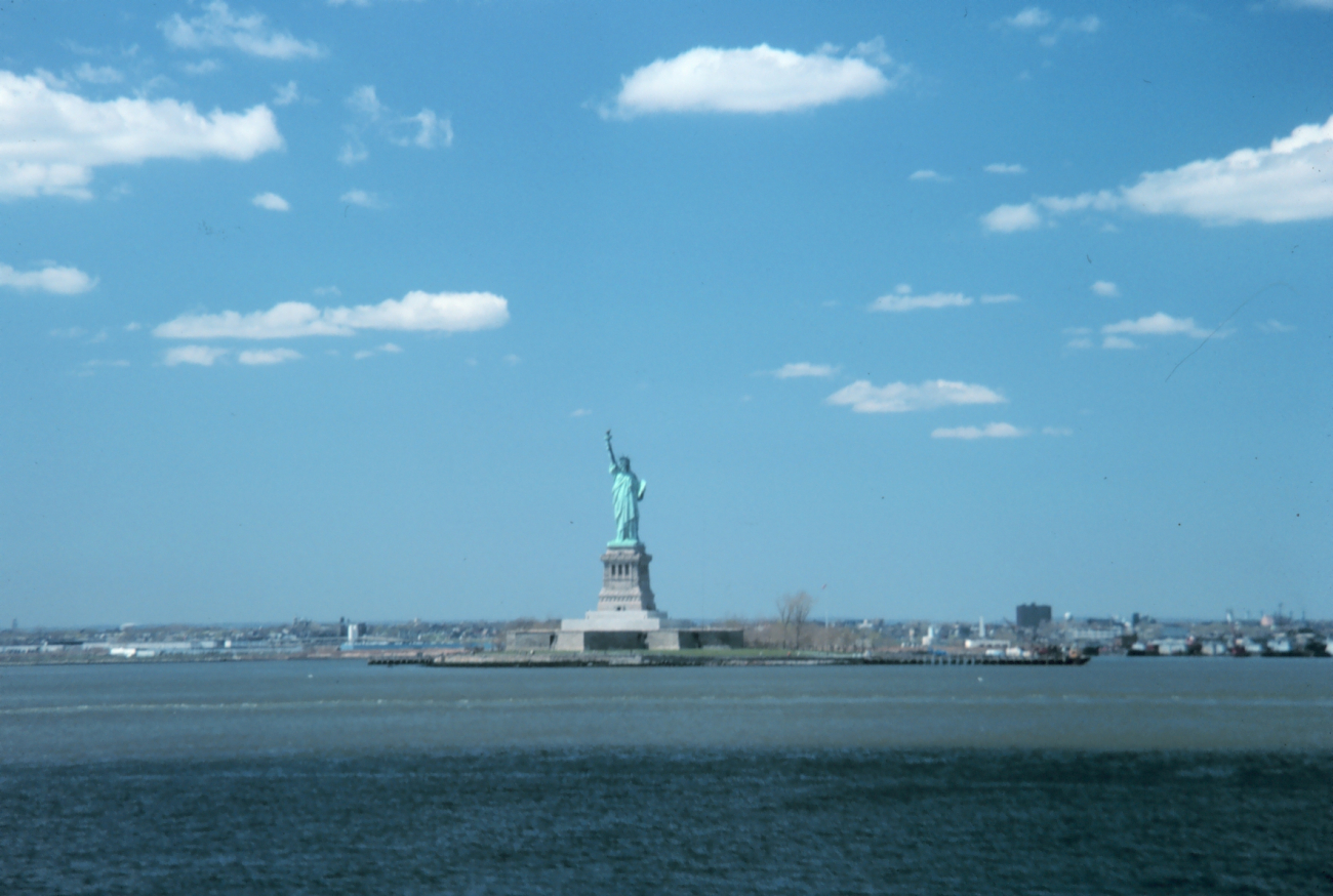 The Statue of Liberty, New York Harbor, with fair weather cumulus