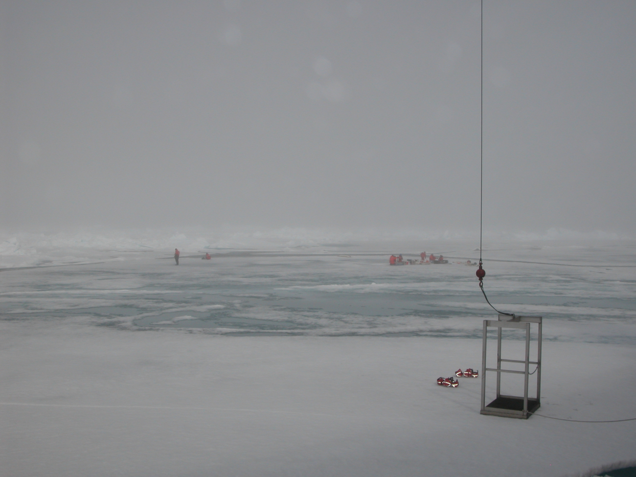 Scientists work on the ice in foggy weather