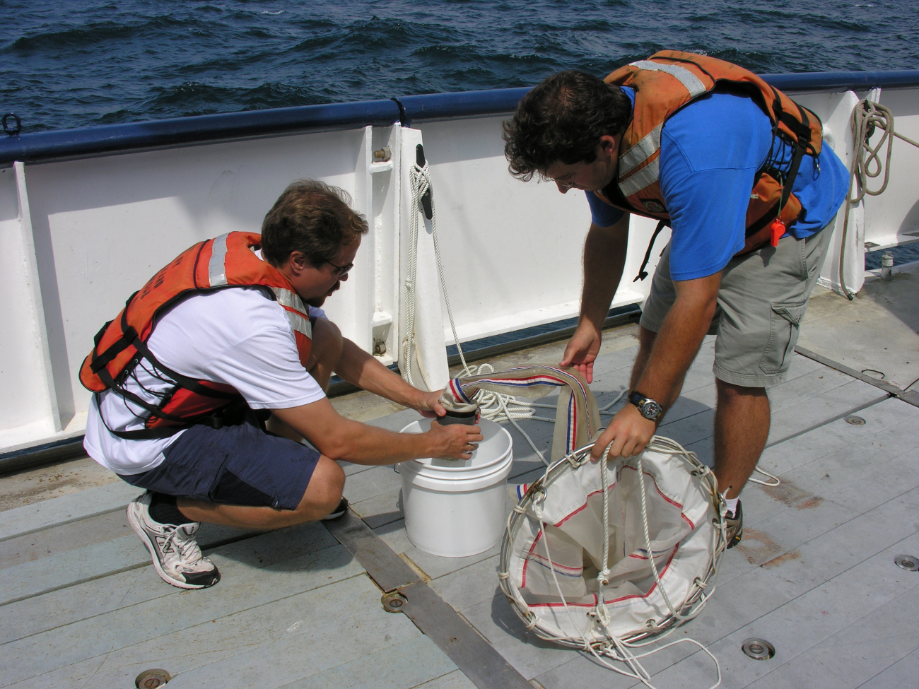 Mikhail Matz and Jon Cohen release the collection bottle from the baseof the plankton net after the tow