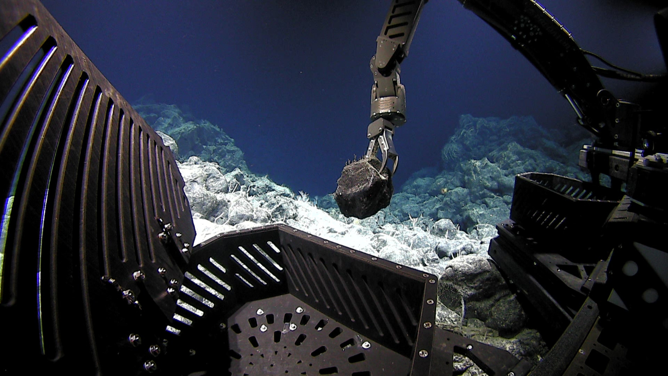 Manipulator arm of Deep Discoverer sampling a rock