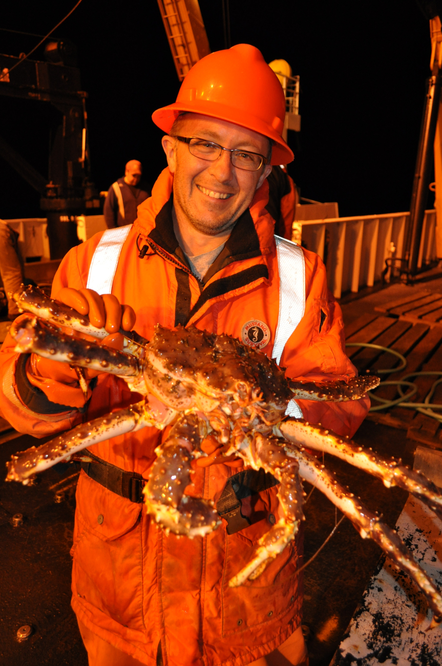 Scientist with large king crab obtained during night operations