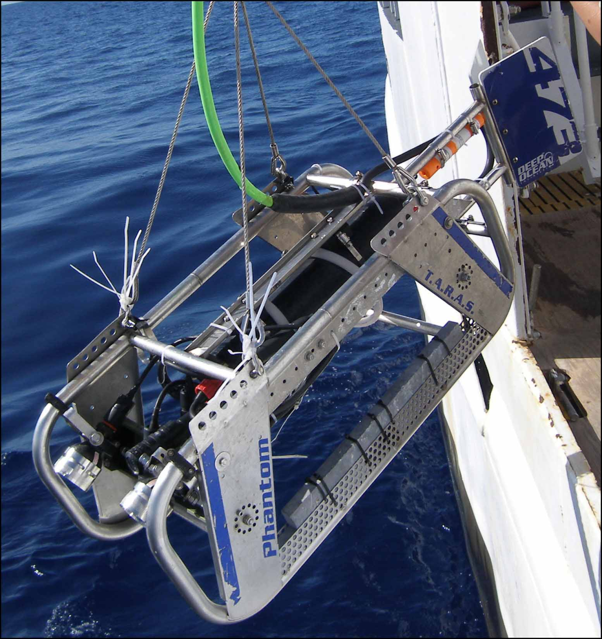 The video and still photographs collected by the towed optical assessmentdevice (TOAD), the camera sled shown being deployed from a ship,  can beanalyzed to help map the character of benthic habitats
