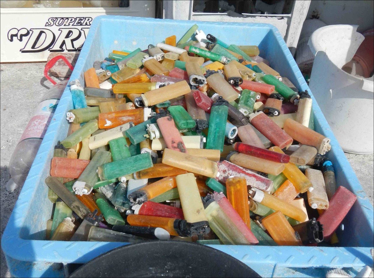 The contents of this plastic crate make up just a portion of the 1249cigarette lighters found on the shores of Midway Atoll in April 2013