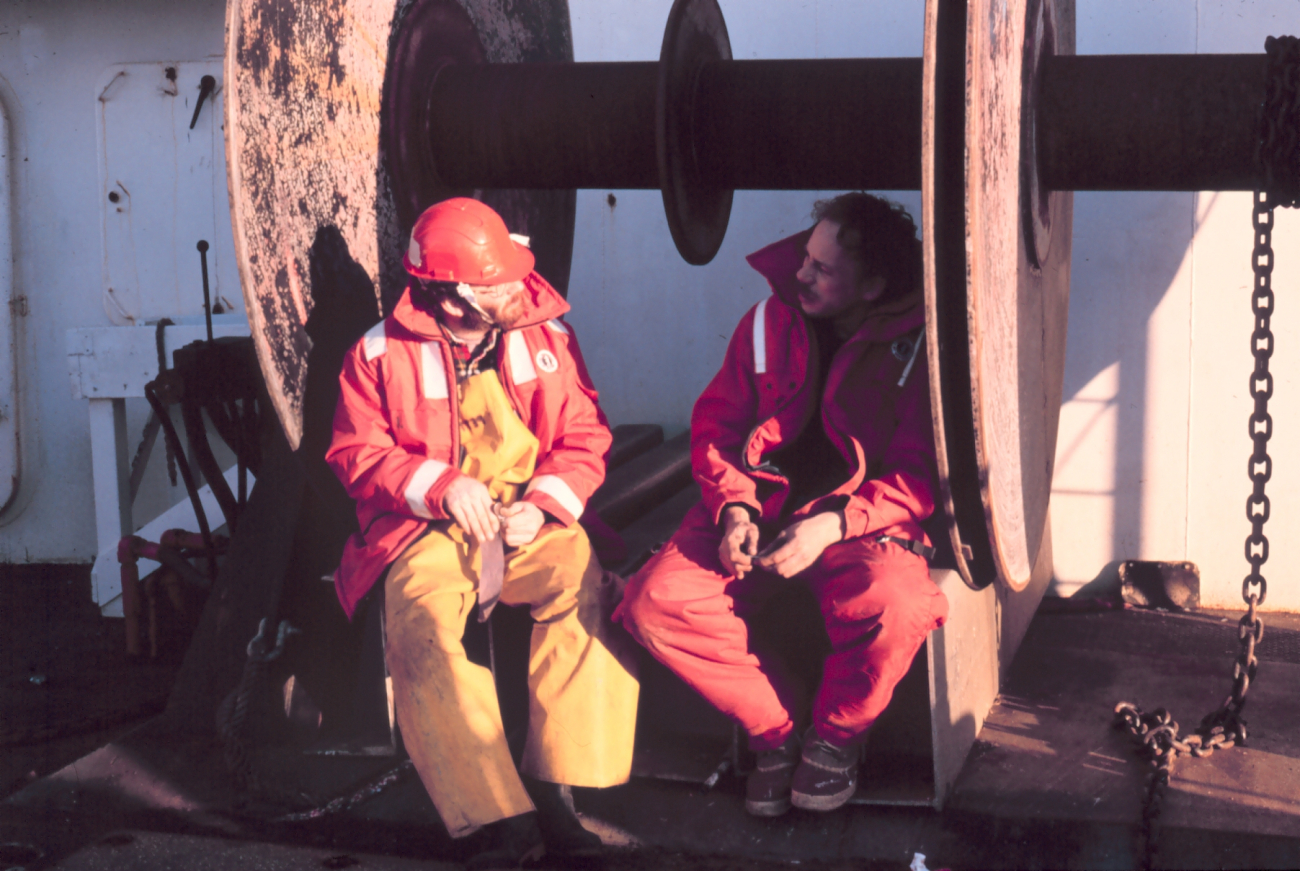 Two crewmen taking a breather during transit between fisheries studies stations