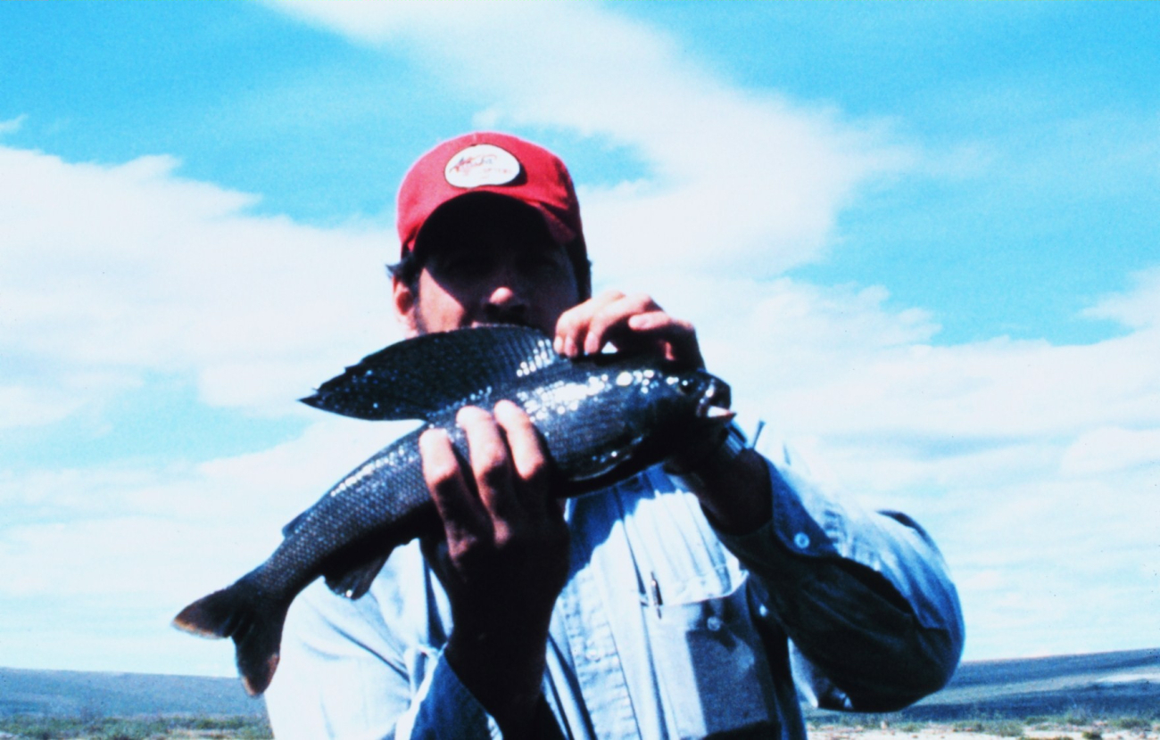 Angler with an Arctic grayling