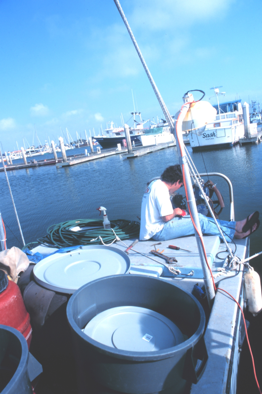 A fisherman working on his gear at the Channel Islands Harbor