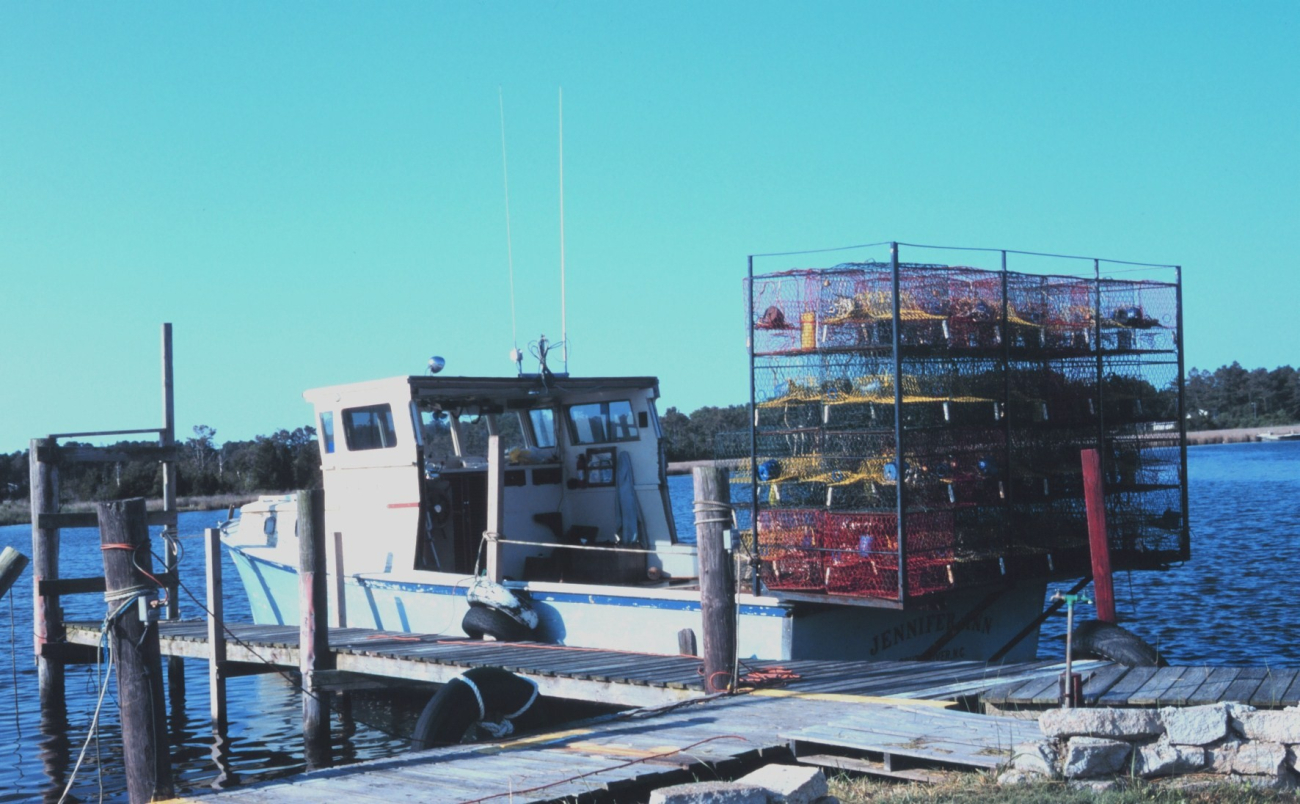 A blue crab fishing boat loaded with pots and ready to go to work