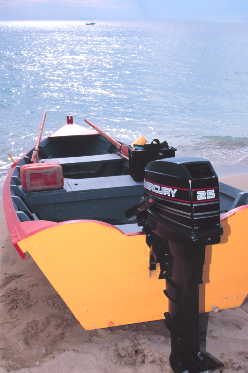 Stern view of a small fishing craft on the beach