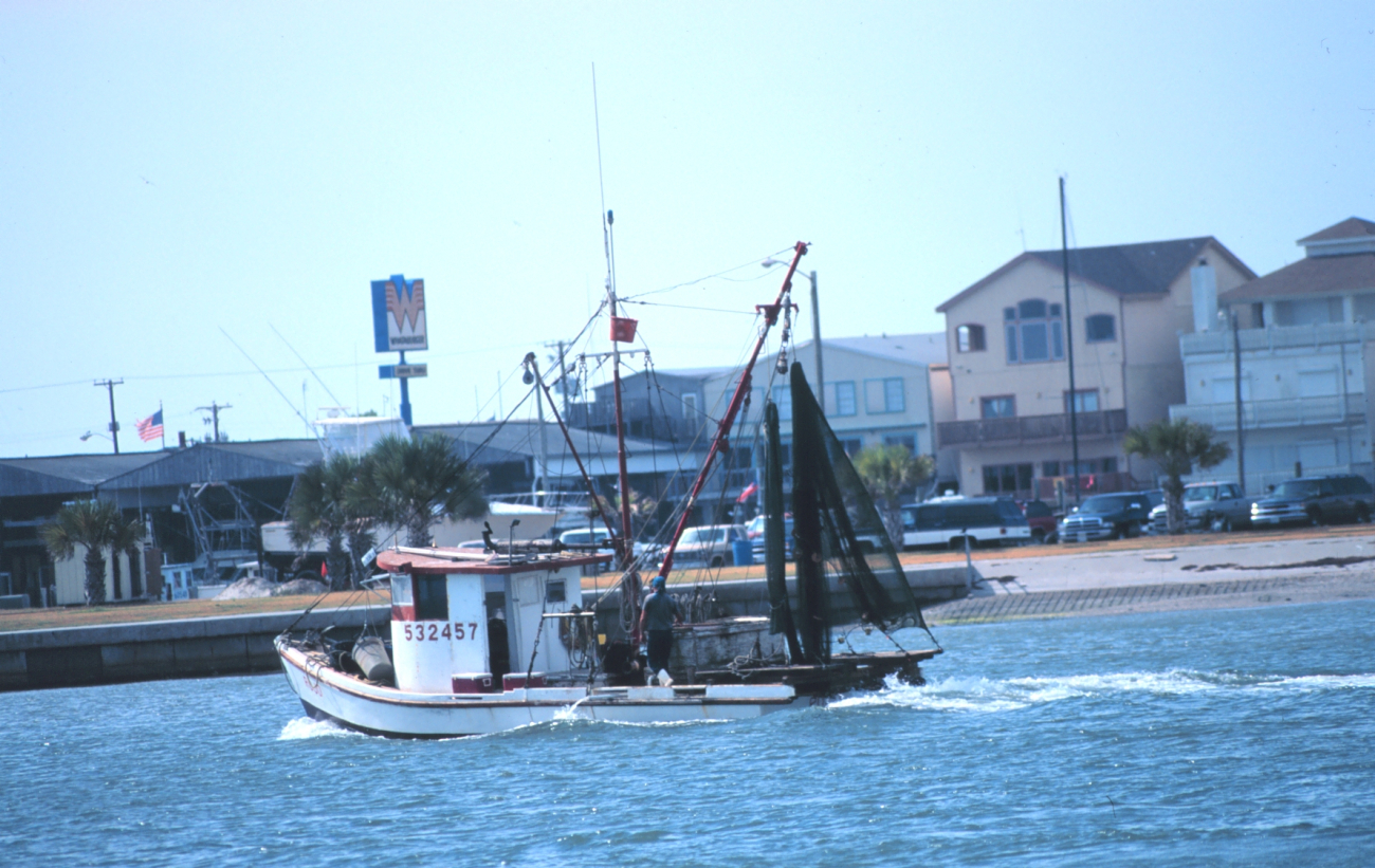 A shrimp boat heads out for the fishing grounds