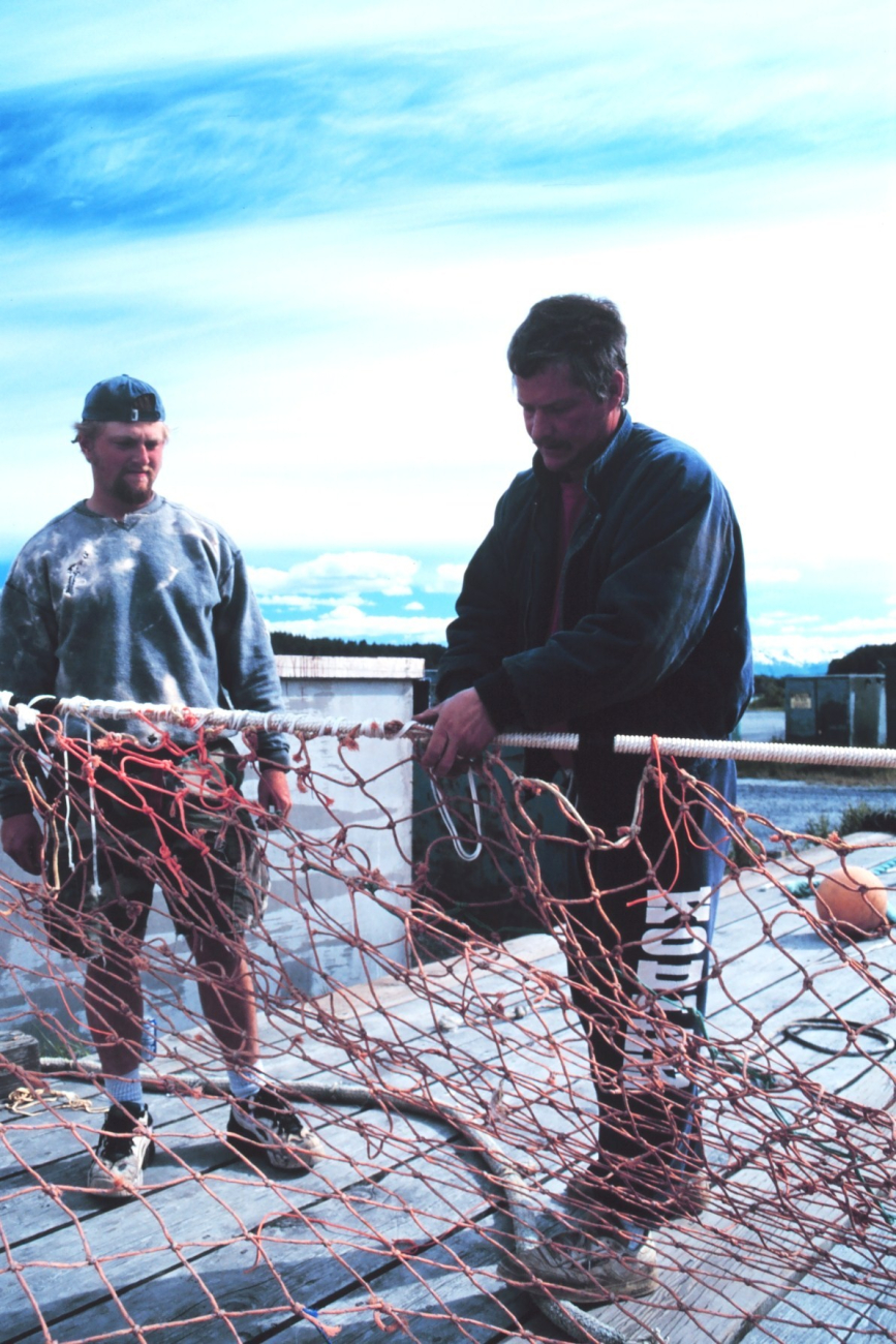 Fishermen mending nets at St