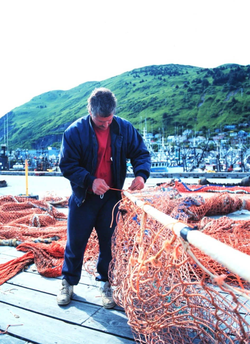 Fishermen mending nets at St