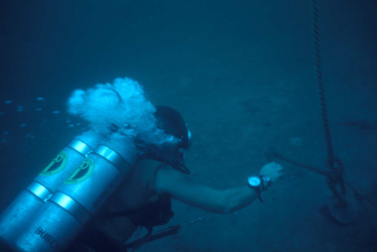 Scuba diver working with underwater equipment deployment