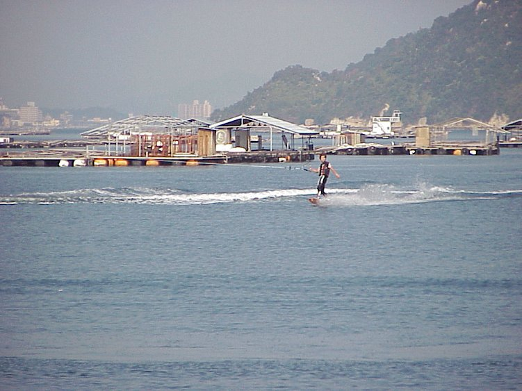 Japanese water skiiing between oyster culture rafts near Nansei