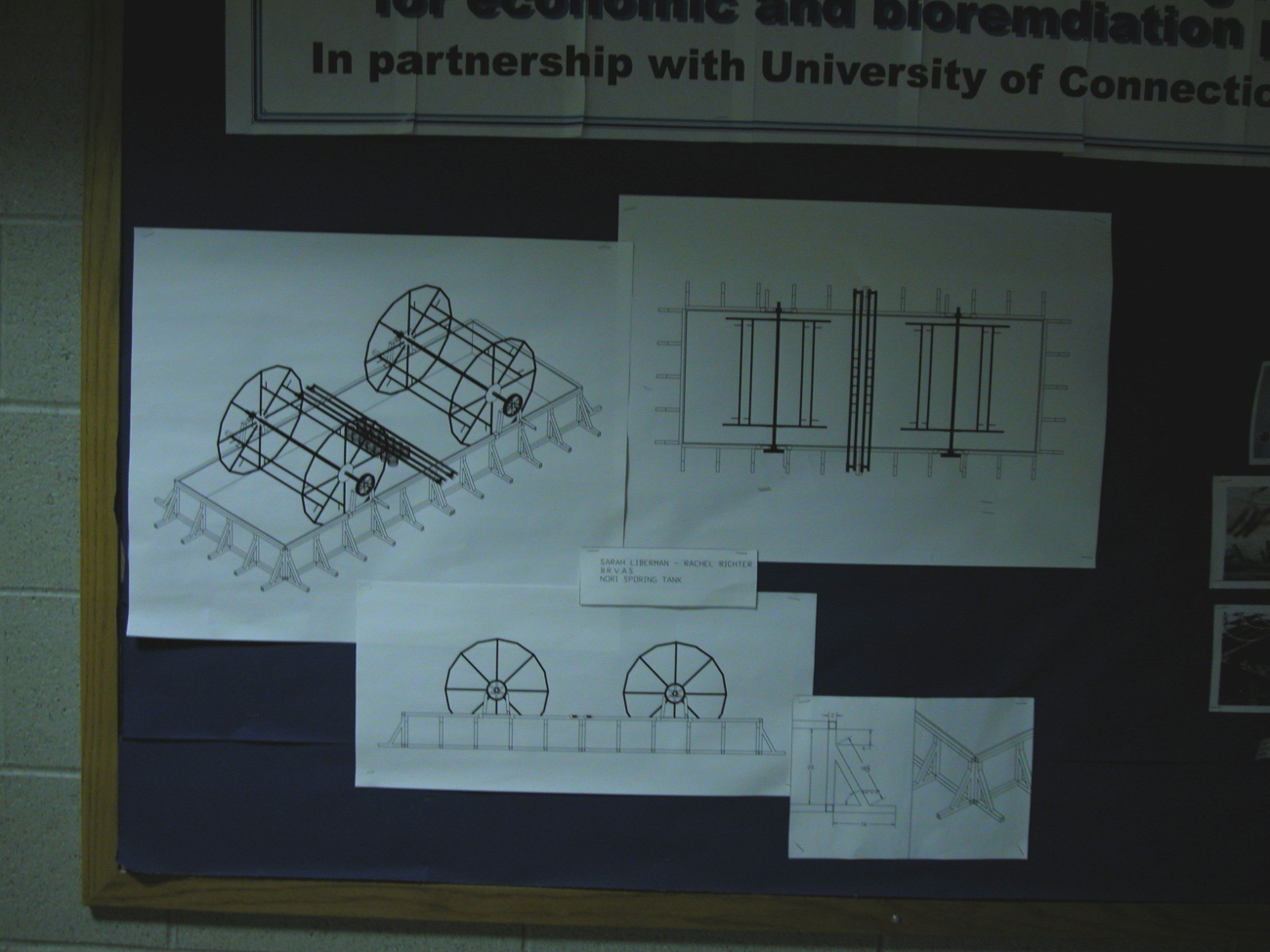 Bulletin board showing diagram of algae system for bioremdiation