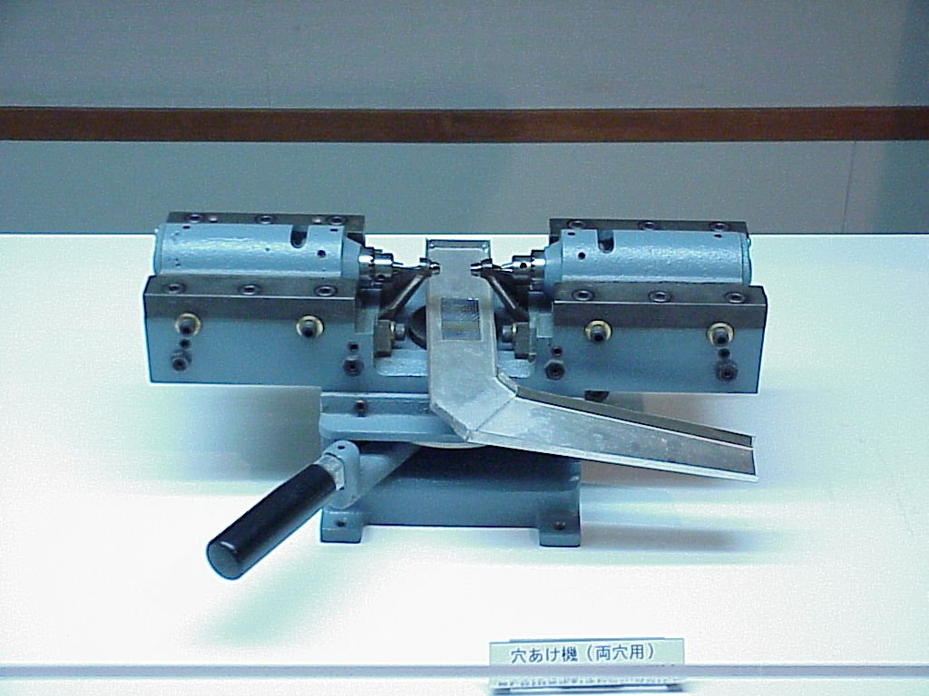 Machine used for holding a cultured pearl in preparation for jewelry making