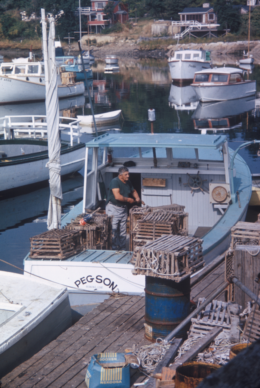 Lobsterman preparing traps and floats before leaving port