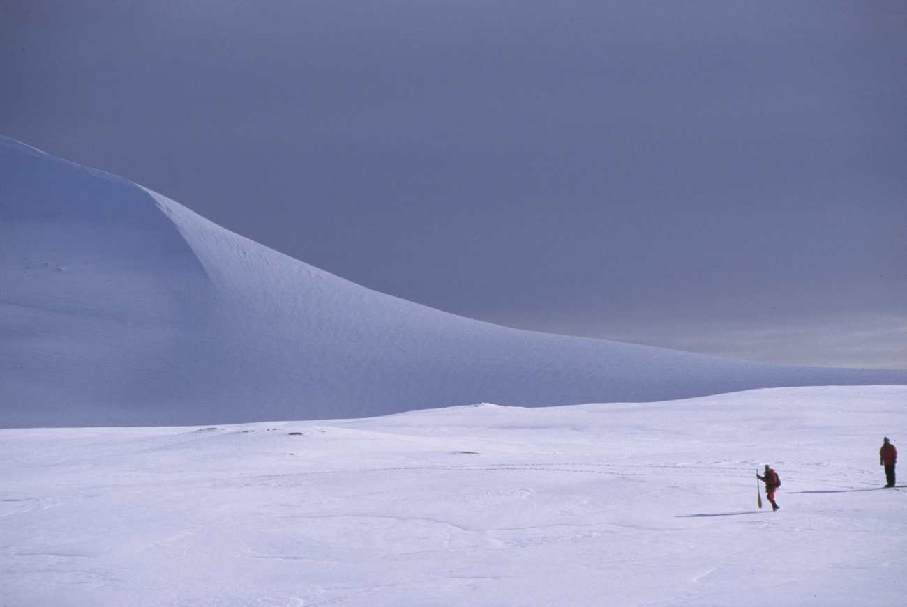 Scientists on a trek across the ice and snow give scale to an Antarcticlandscape
