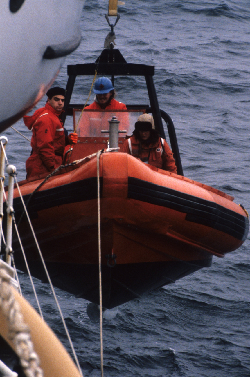 Researchers deploy a small RHIB (Rigid-Hulled Inflatable Boat)from the main research vessel