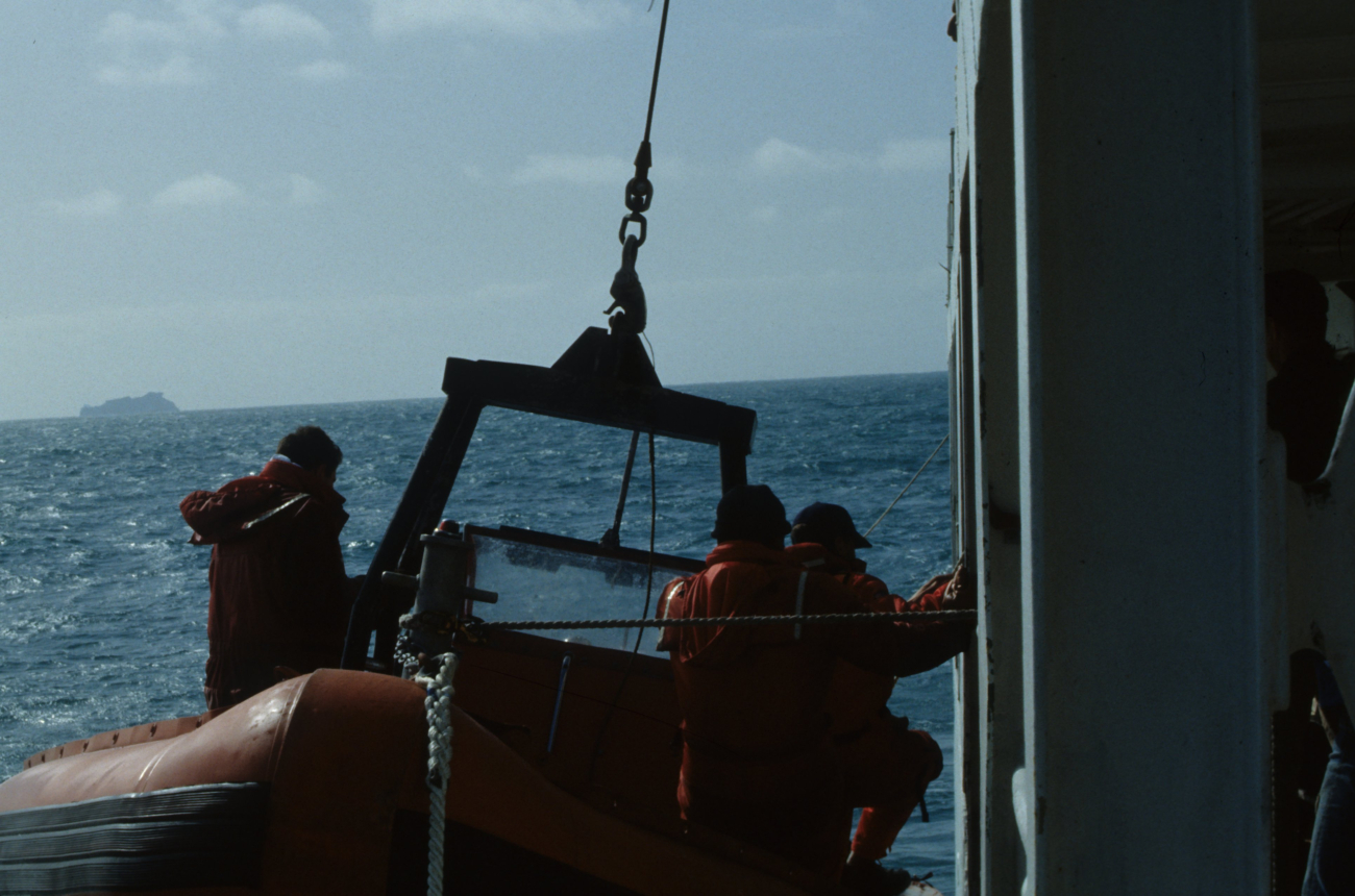 AMLR scientists deploy a small boat from the R/V Surveyor to carrysupplies to the AMLR field stations
