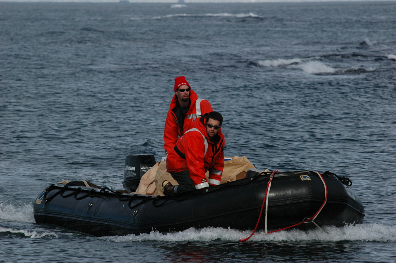 AMLR scientists Anthony Cossio and Ryan Driscoll in a Zodiac,been outfitted with a satellite tag and time depth recorder,which drop off when the bird molts
