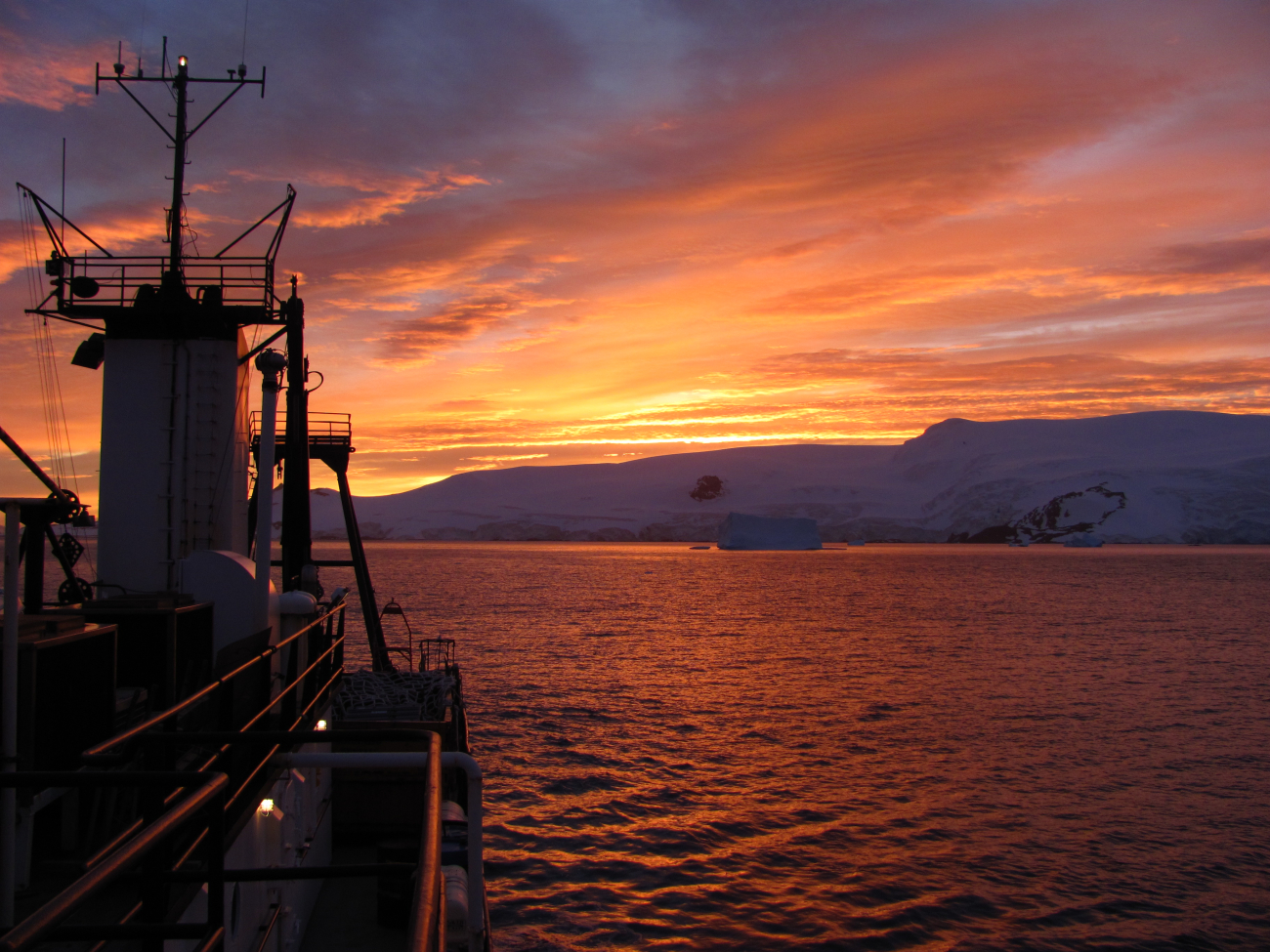 The sun rises over the R/V Moana Wave in Discovery Bay, Antarctica