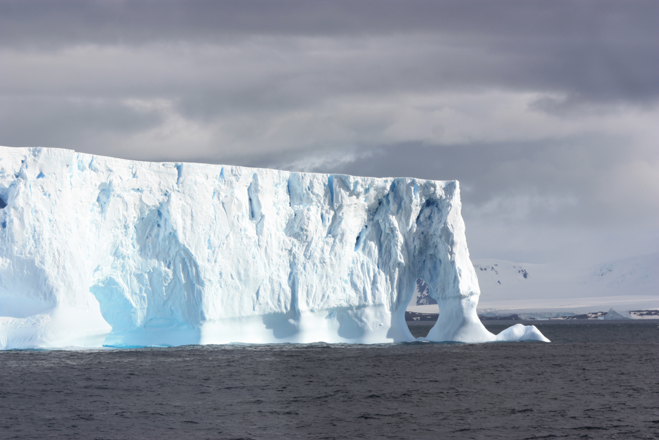 The edge of a tabular iceberg, sculpted by the ocean